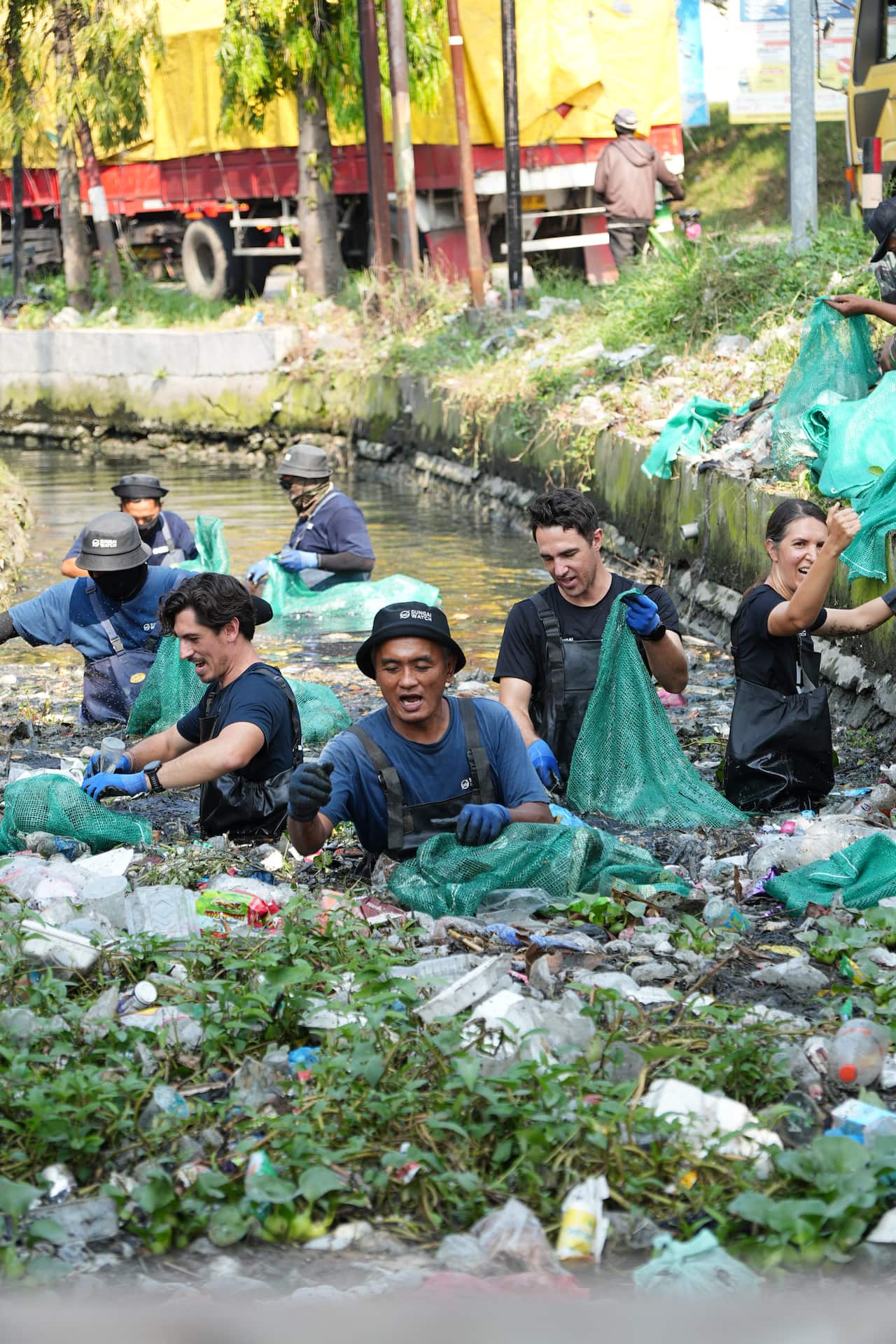 The Sungai Watch team sort through plastic waste collected from a riverside during a stop on the Bali-to-Jakarta run.