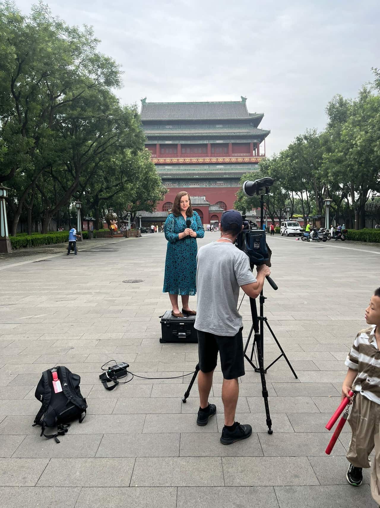 A journalist stands in front of a camera.