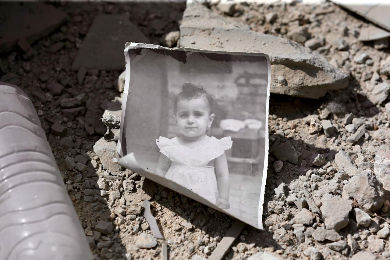 A photograph of a child lies on the ground following an airstrike.