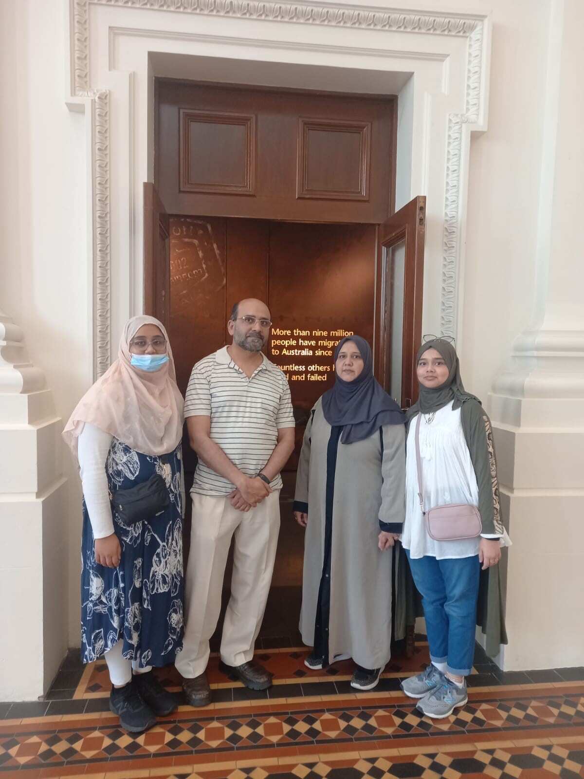 Man standing with his family.