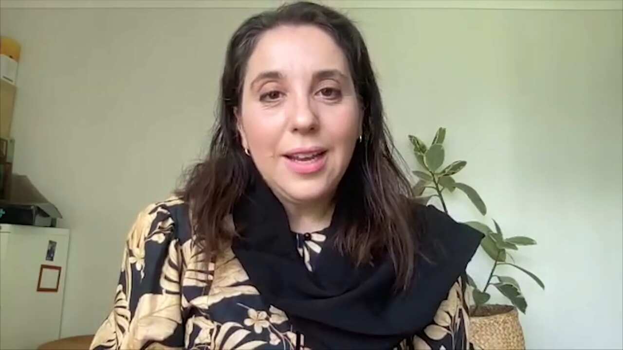 Woman speaking on camera.