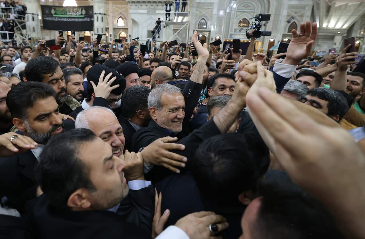 Iran’s new president Pezeshkian speaks to media at the Khomeini shrine