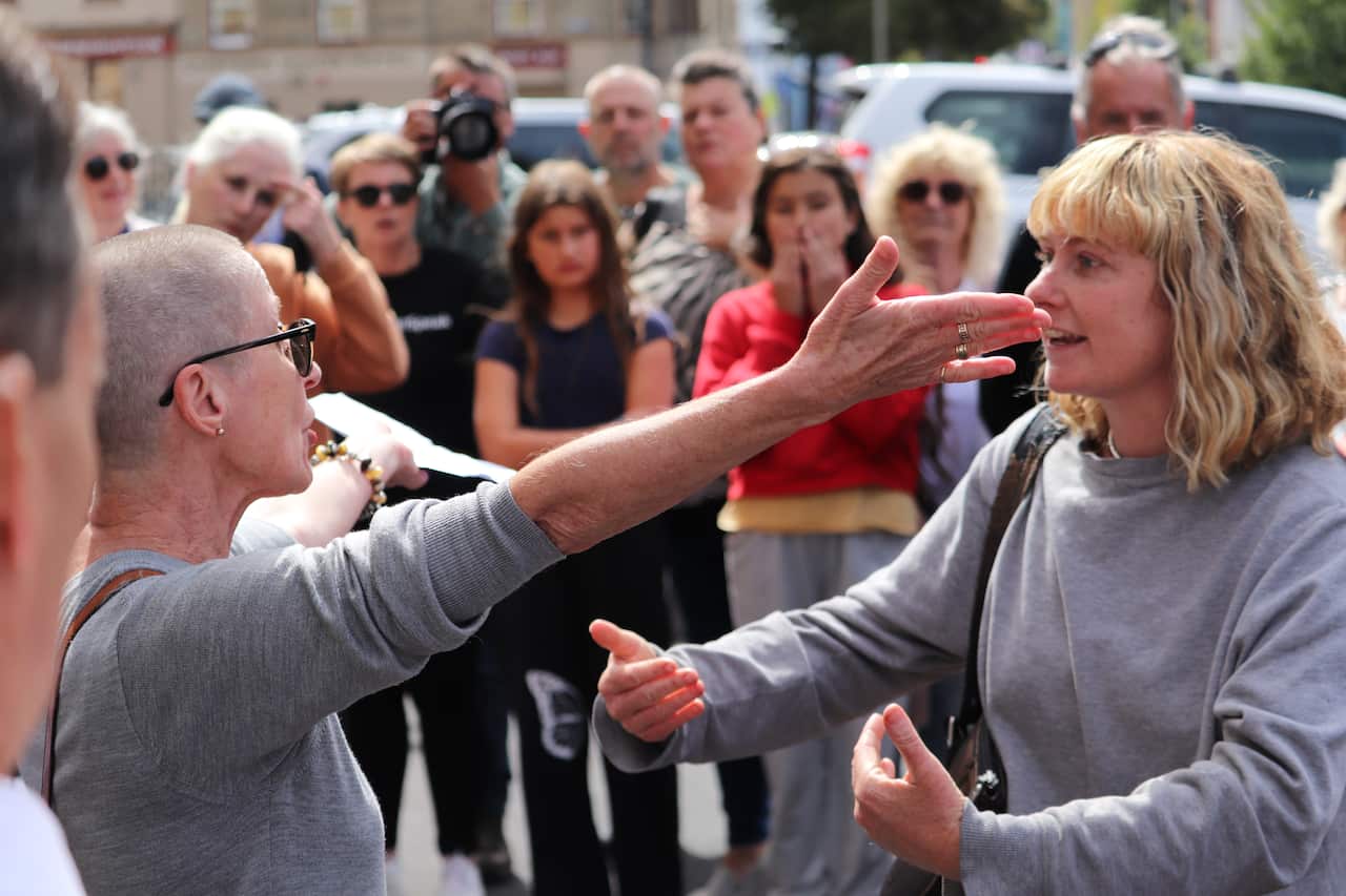 Two women argue with each other.