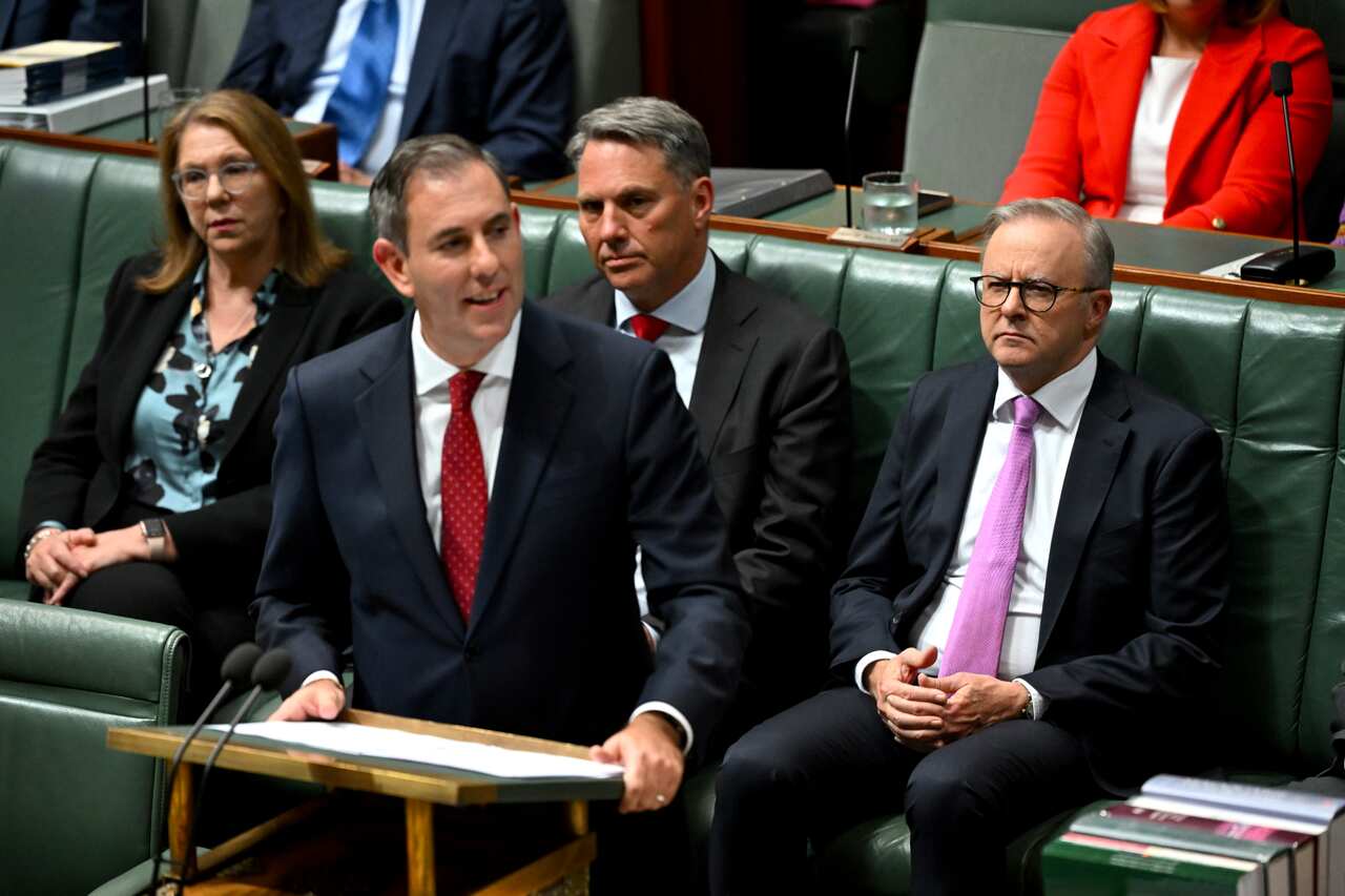 Prime Minister Anthony Albanese listens as Treasurer Jim Chalmers delivers the 2024/25 Budget