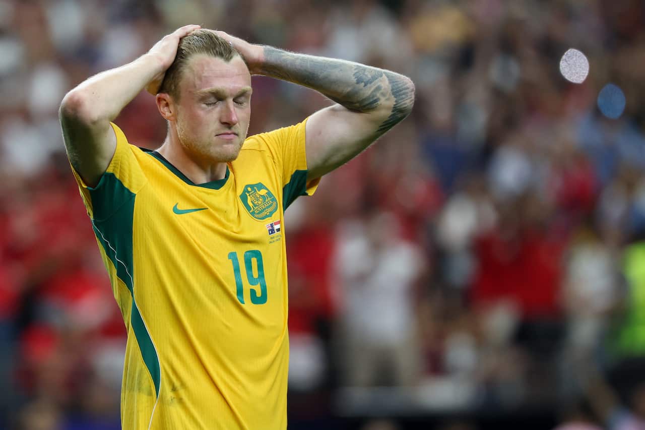 A football player holding his hands on his head