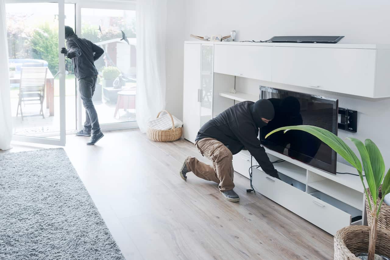 Two burglars at work in an one-family house at daytime