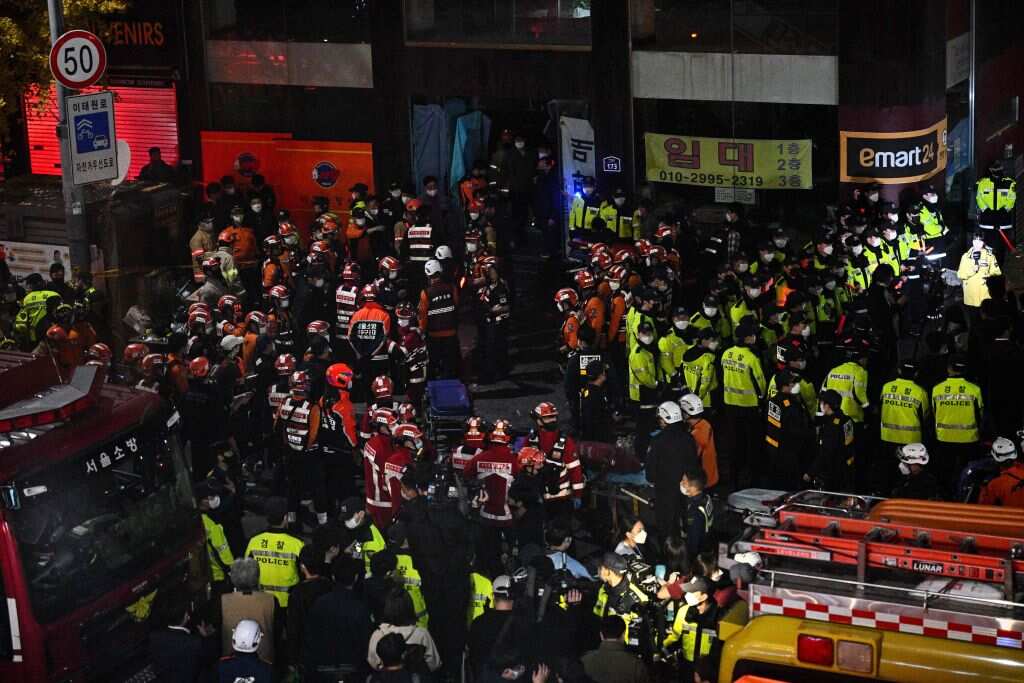 Rescue officials and police gather in the district of Itaewon in Seoul after a Halloween crush that left at least 140 people dead.