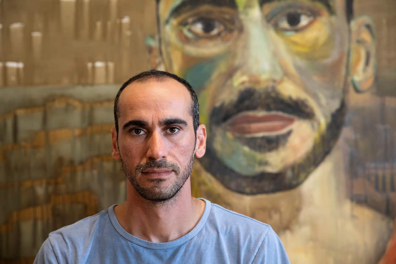 Archibald prize entrant Mostafa Azimitabar in front of his self portrait