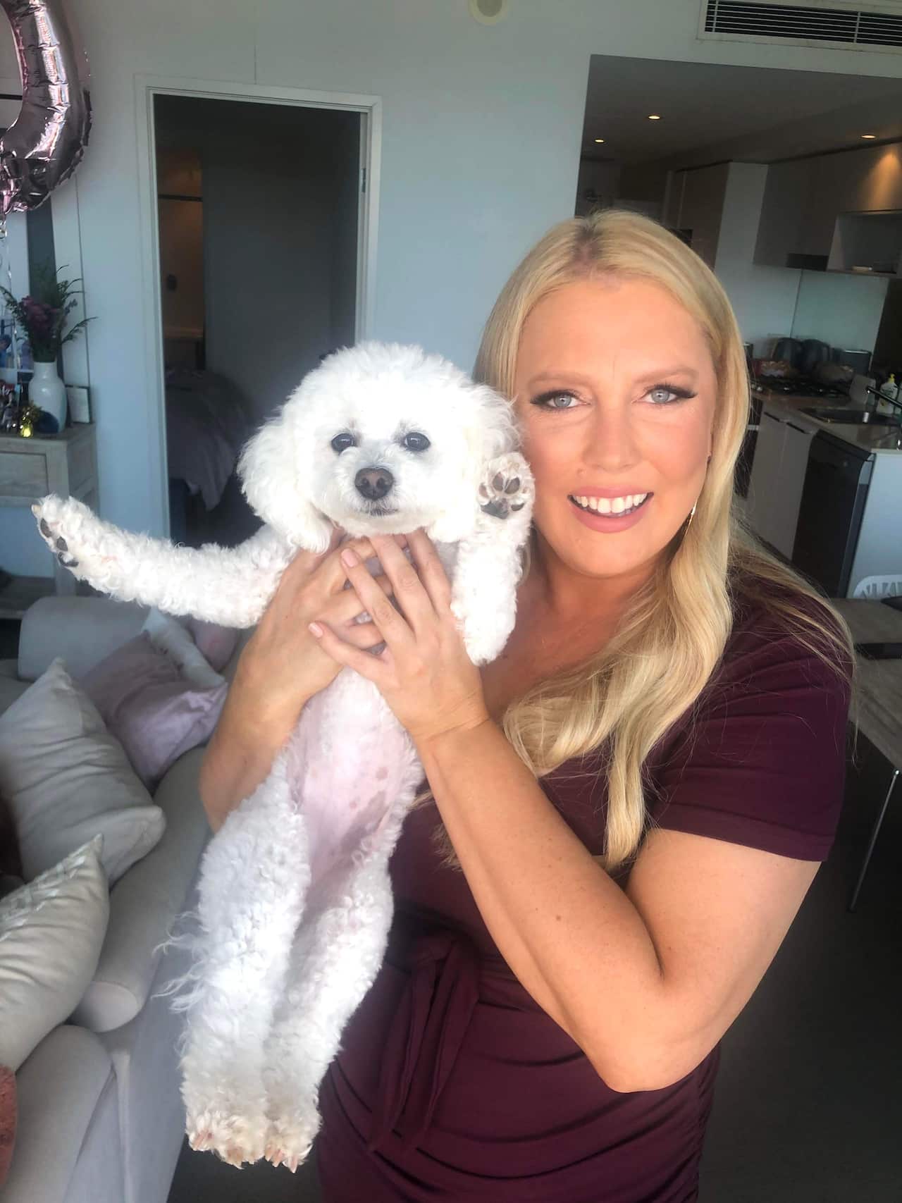 Mel Greig holding her pet dog. 