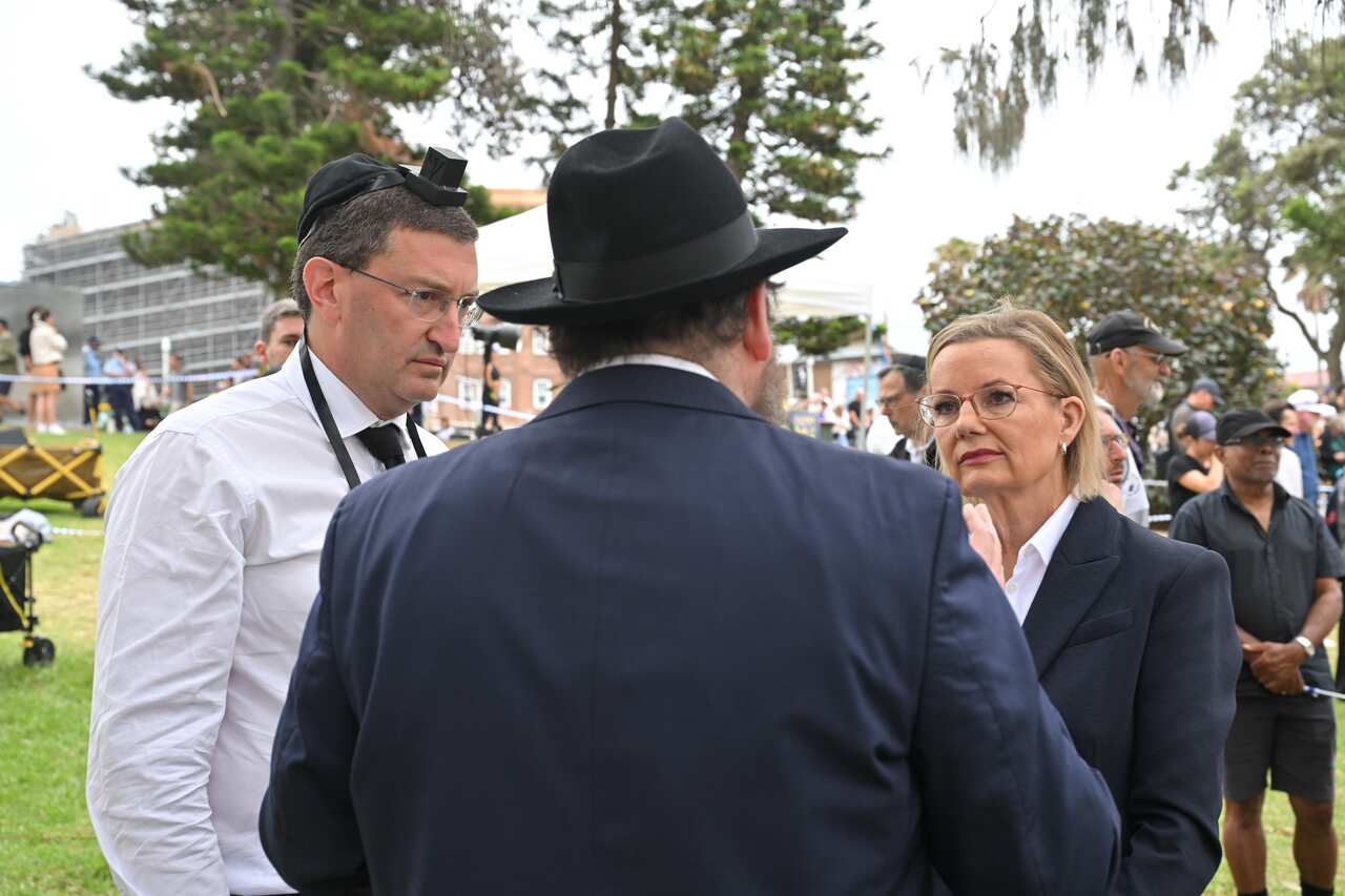 A woman talking to two men.