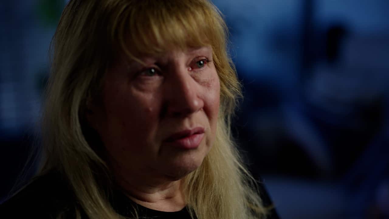 A woman with blonde hair looks distressed.