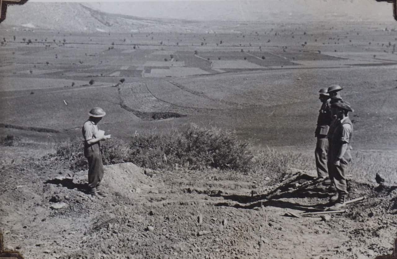 A burial service in the field, with Mt Olympus in the background. Central Greece, April 1941. 