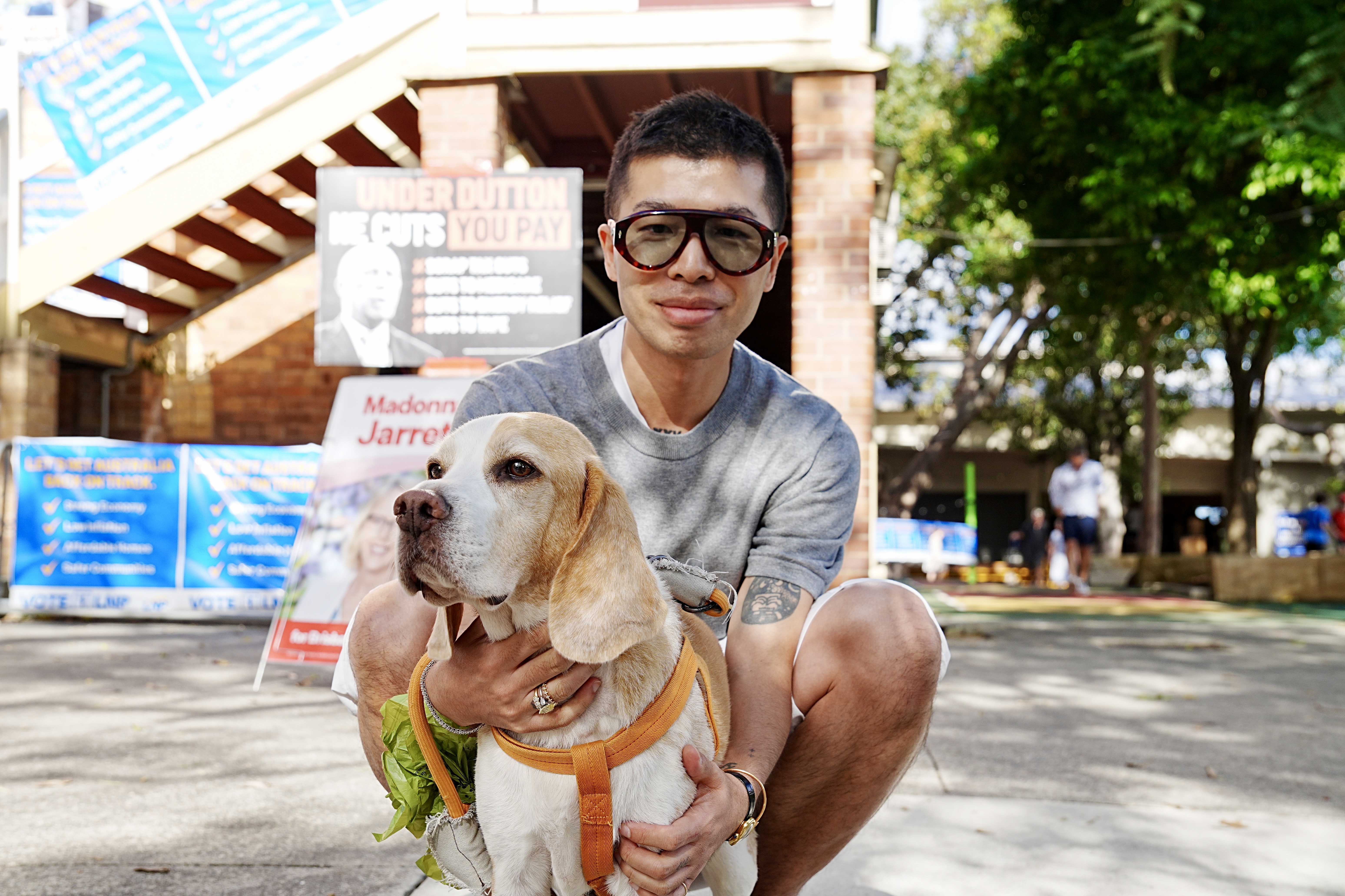 A man with a dog smiles