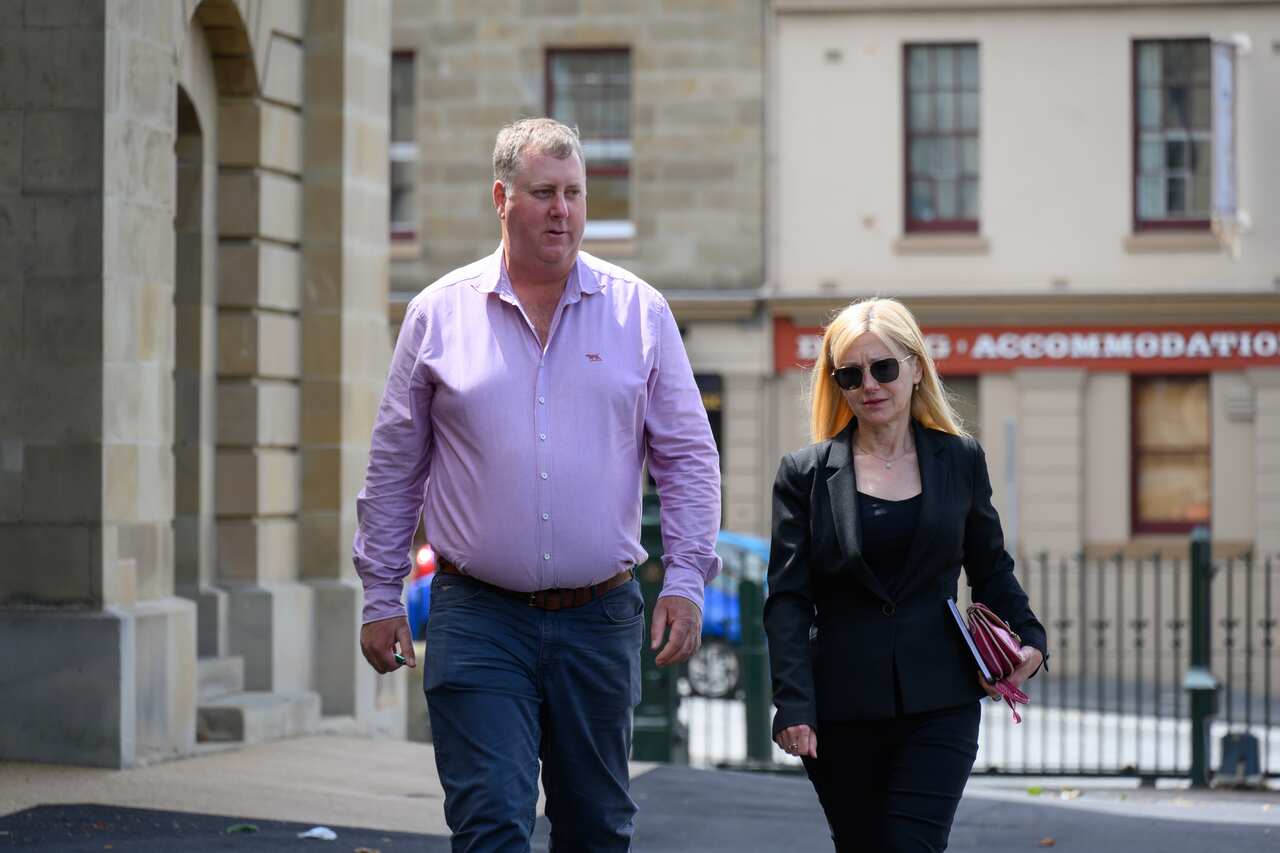 Independents John Tucker and Lara Alexander walking in front of Parliament House in Hobart.