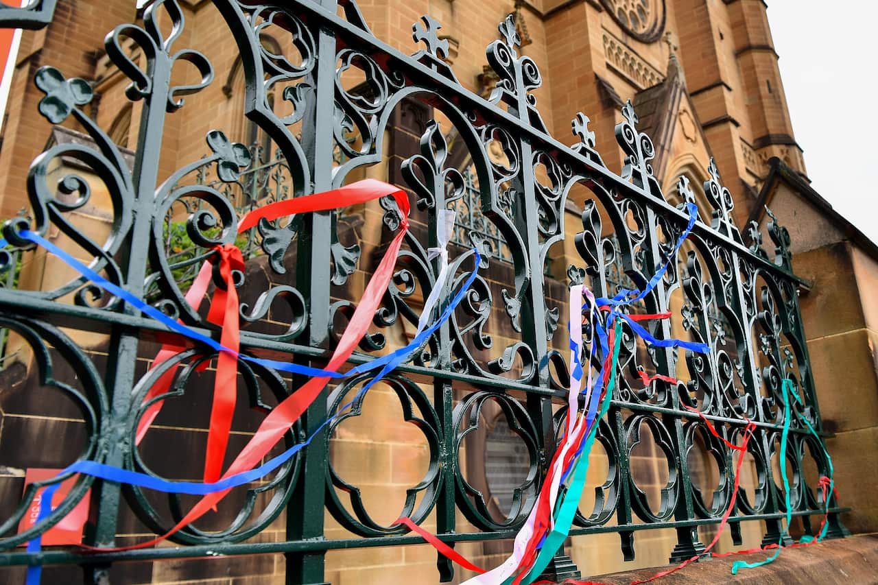 Clergy sexual abuse survivors have tied ribbons onto the fence at St Mary’s Cathedral to remember the lives lost and damaged from the abuse.