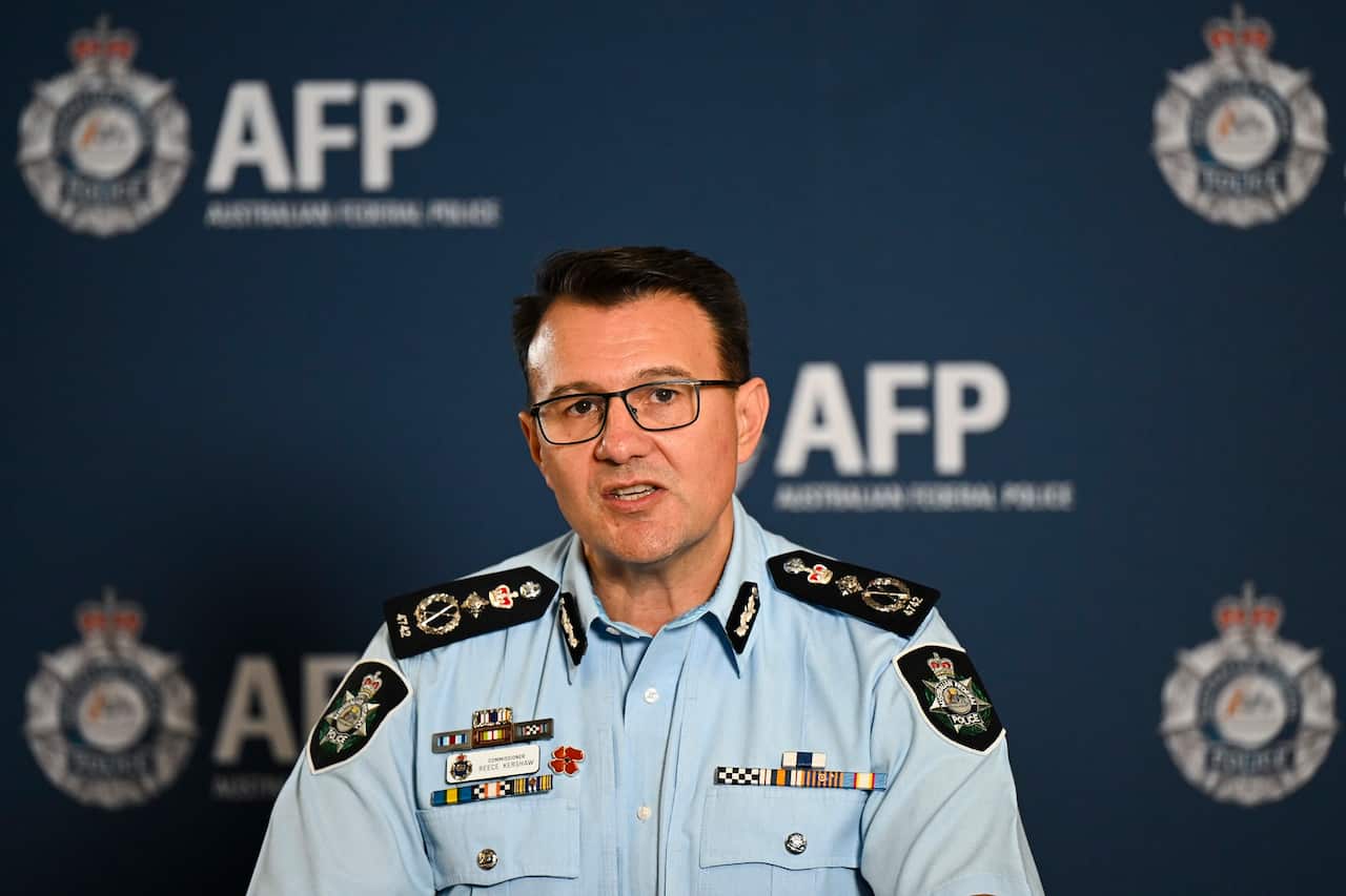 A man wearing an Australian Federal Police uniform who is speaking.