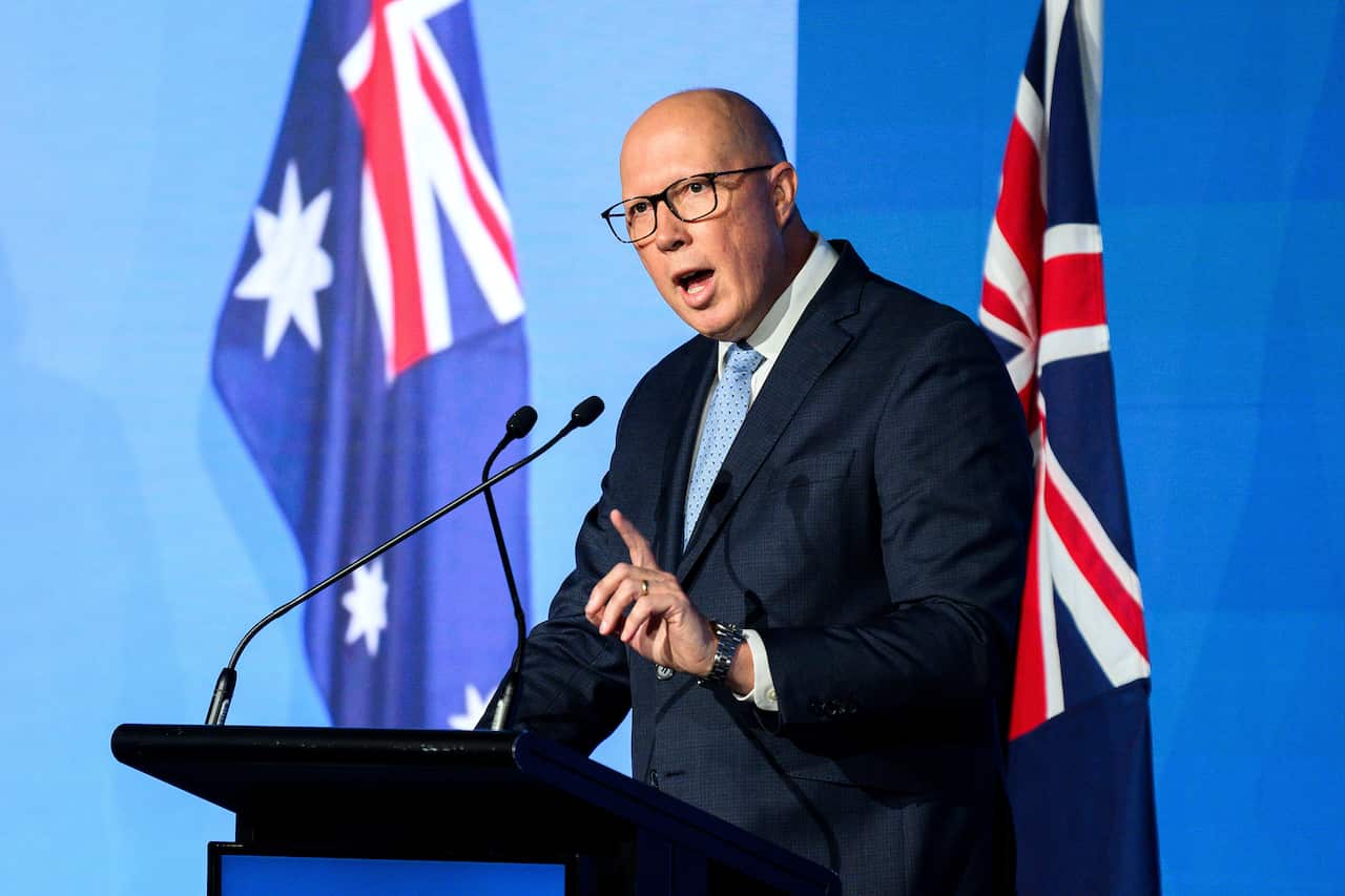 Peter Dutton on a stage, giving a speech.