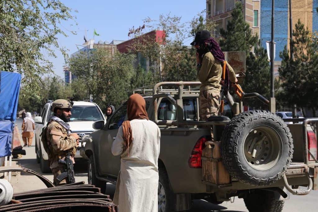 Security forces are pictured standing guard after a suicide bomb attack on an education institute in Kabul, Afghanistan. 