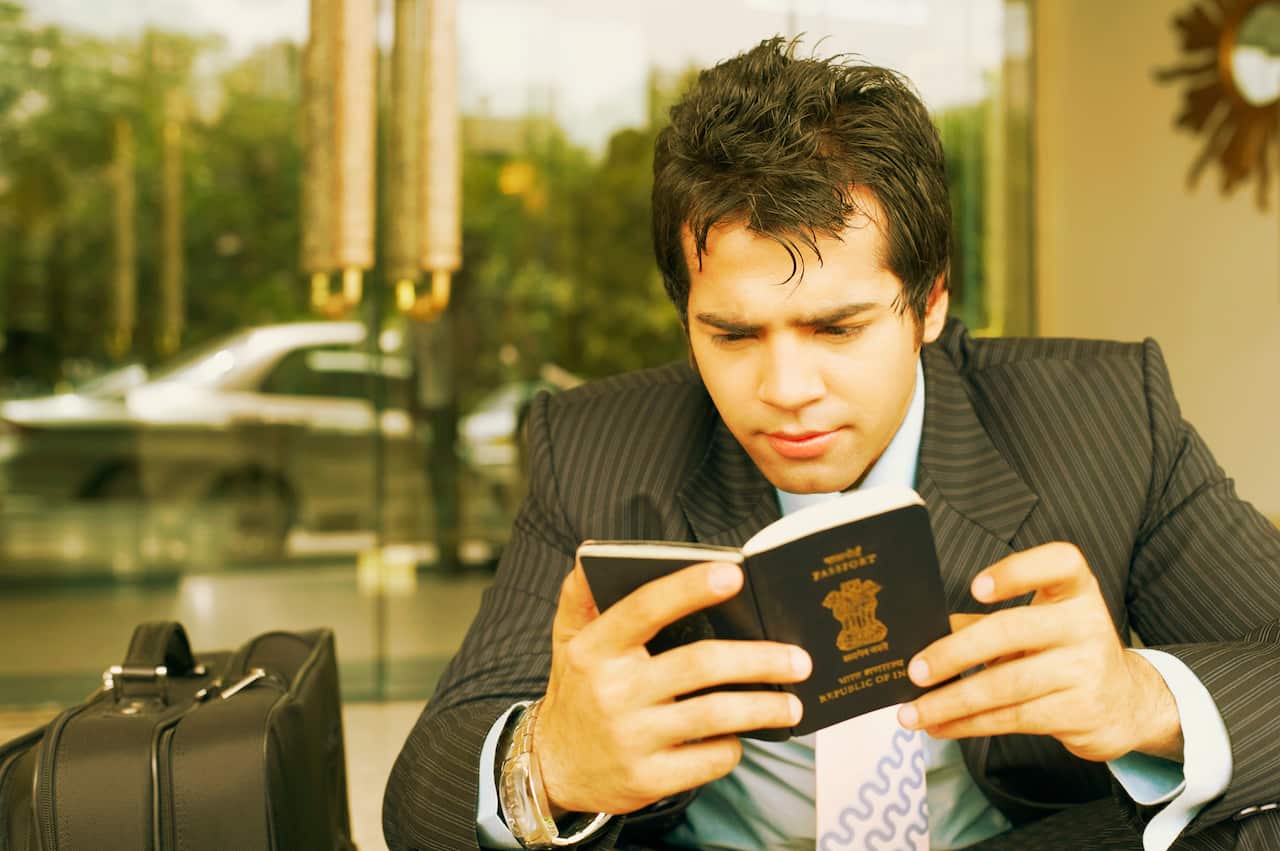 Close-up of a businessman looking at a passport