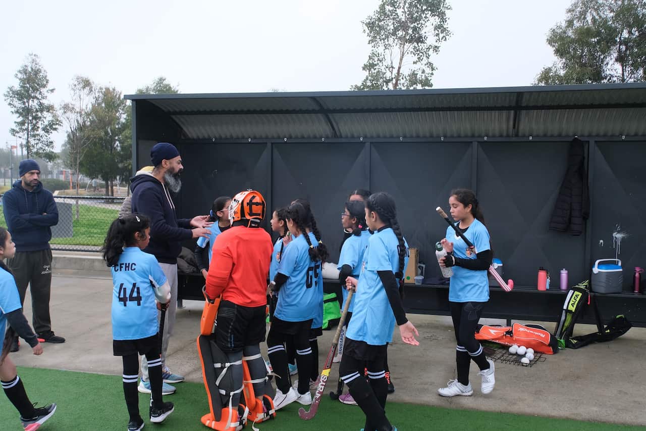 Hockey Coach Paramjot Singh with Girl's hockey team of Craigieburn Falcons Hockey Club..jpg