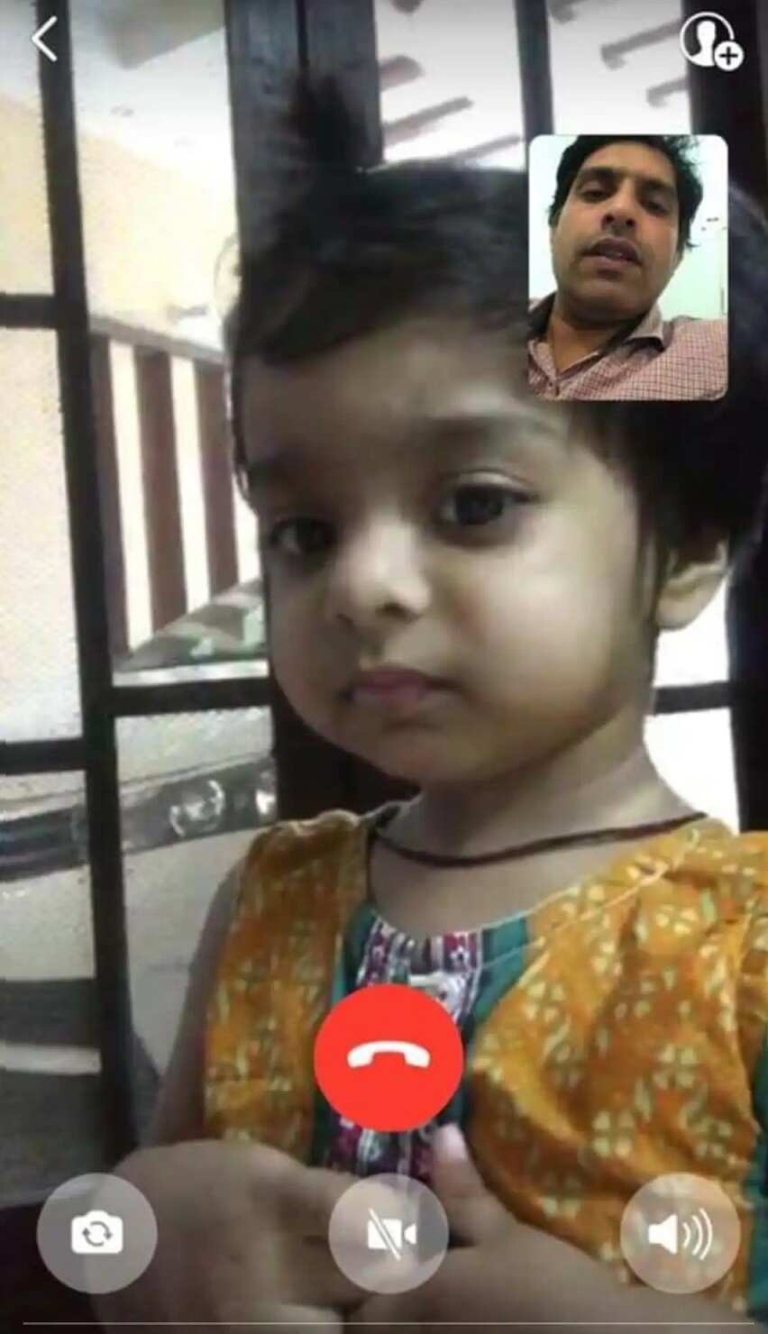 Aminah Imtiaz talks to her father over video call.