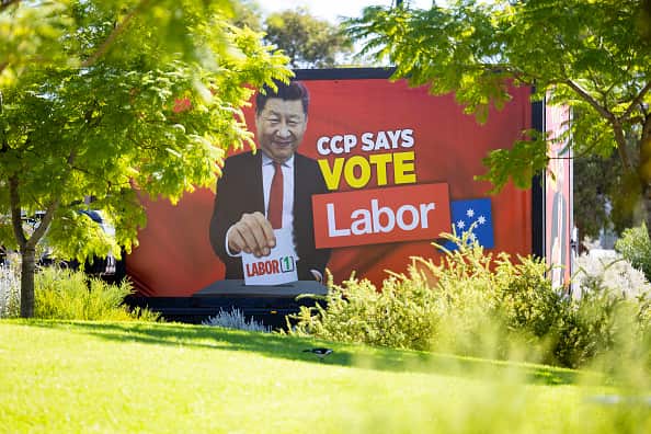 A truck featuring a billboard with the words 'CCP says vote Labor'.