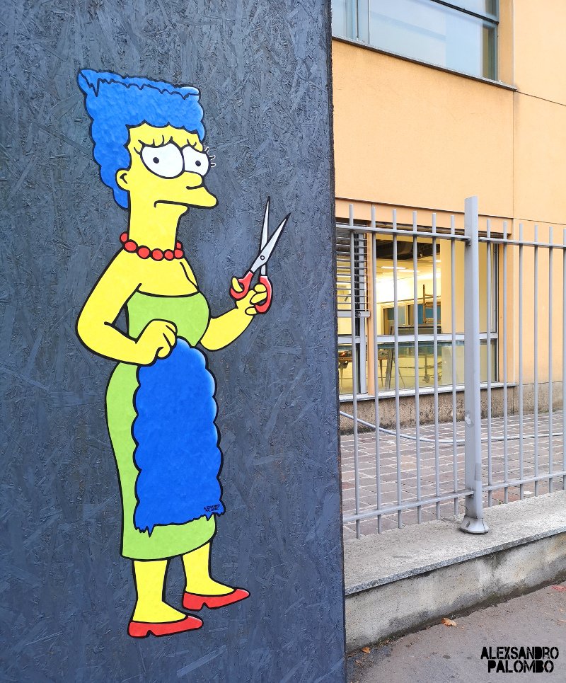 Marge Simpson carries blue hair in painting on wall. 