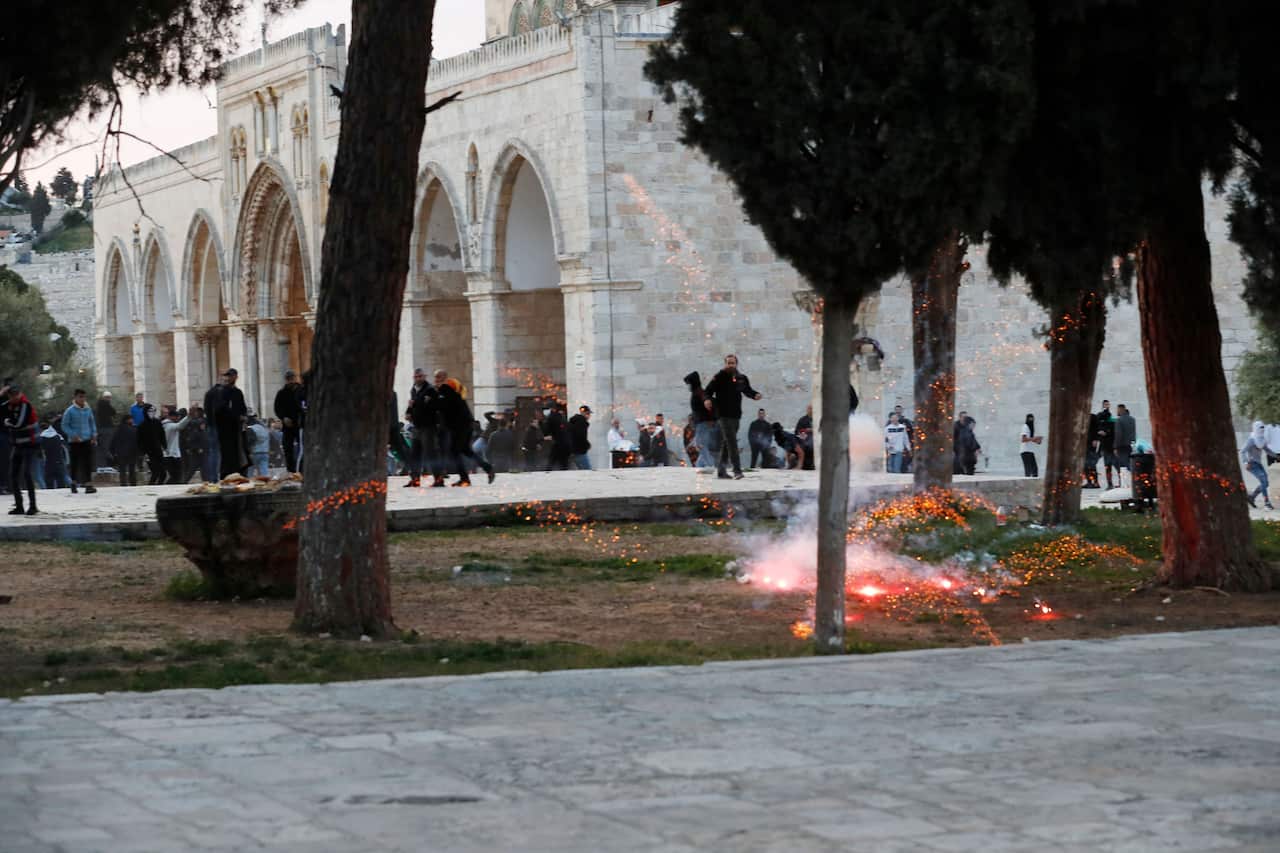 Palestinian demonstrators clash with Israeli police at Jerusalem's Al-Aqsa mosque compound after the morning prayer in east Jerusalem on April 22, 2022, on the third Friday of the holy month of the Ramadan.