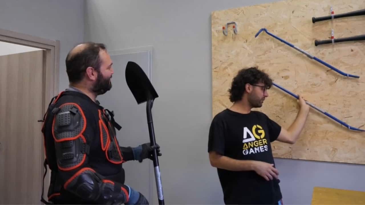 A participant chooses his weapon to enter the Rage Room (AP).jpg