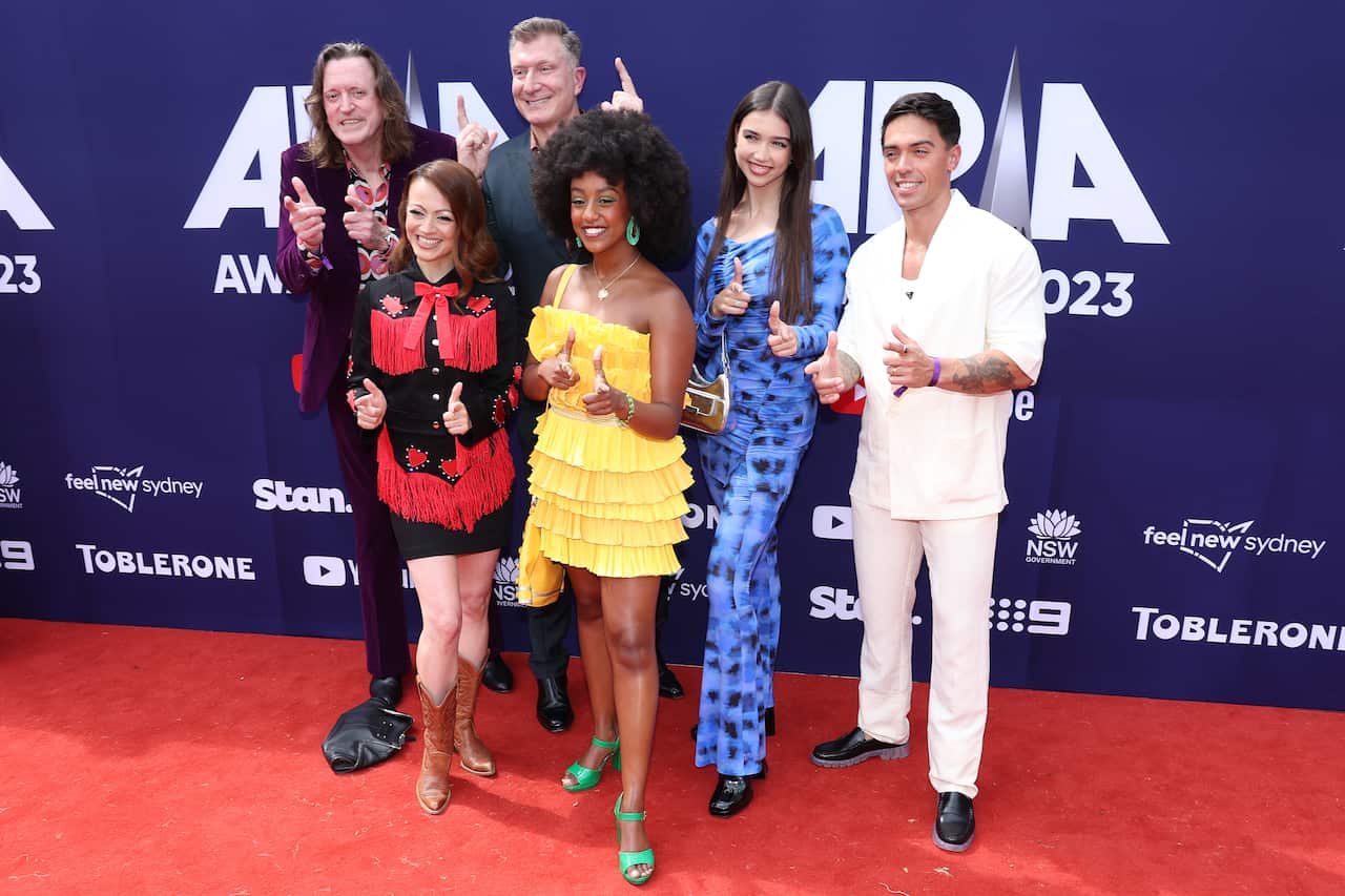 Member of The Wiggles standing on a red carpet