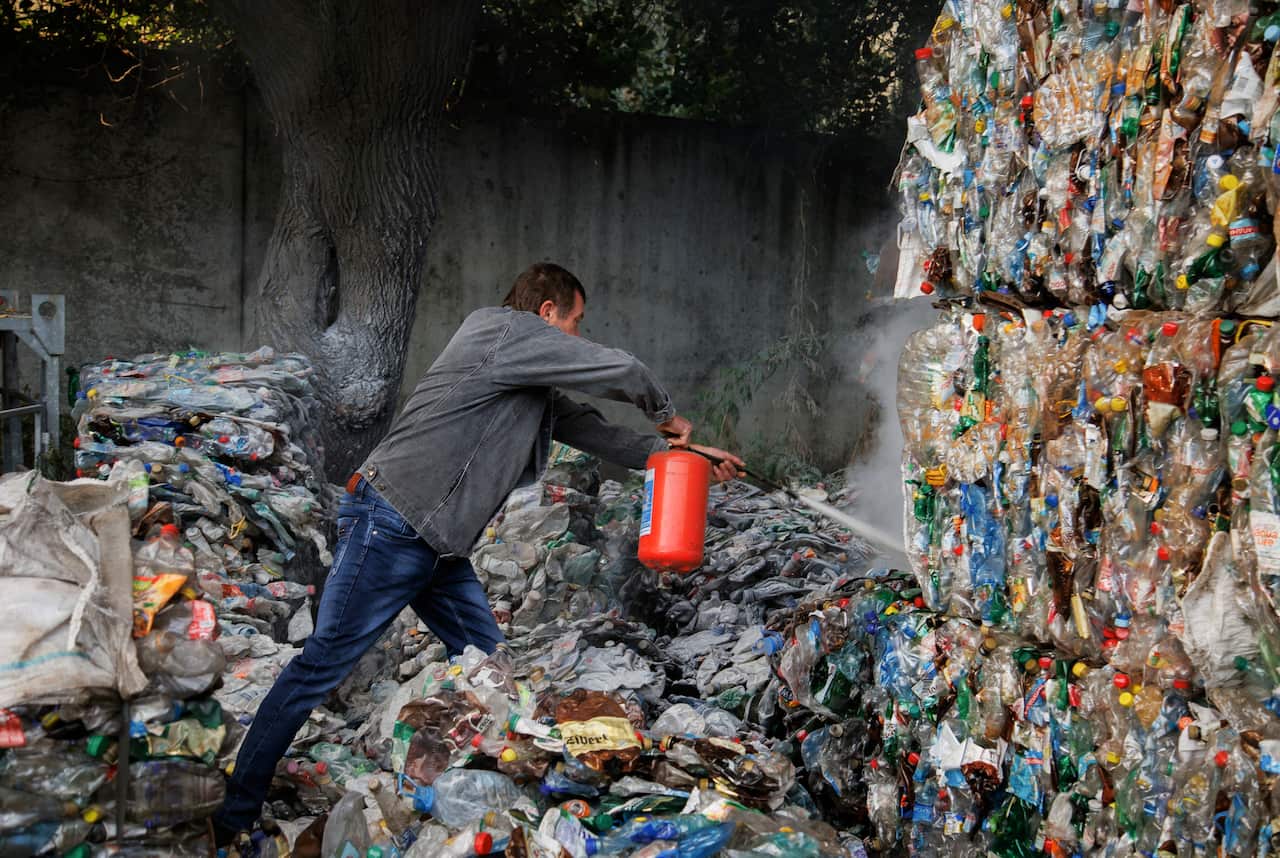 A man using a fire extinguisher. 