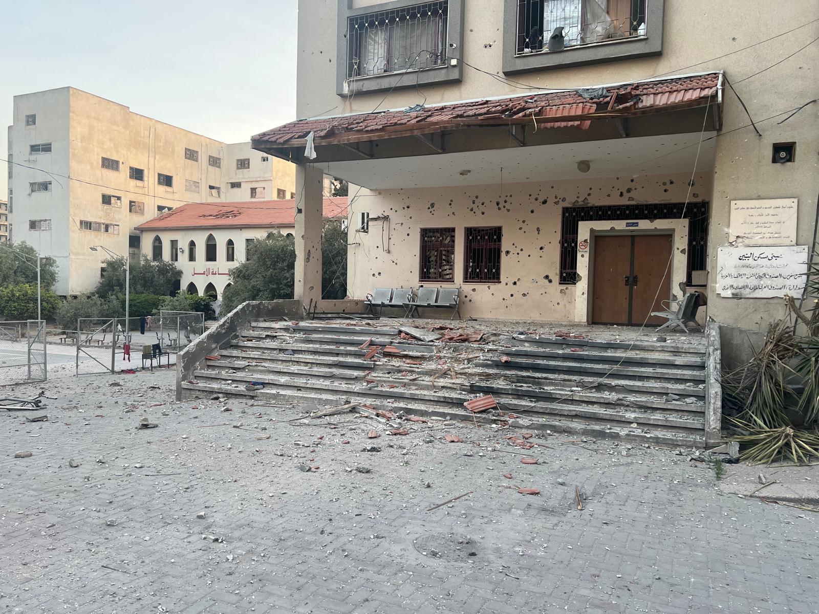 Holes in the wall and debris on the steps of damaged buildings. 