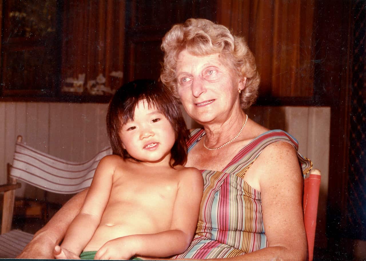 A woman holds a baby on her lap