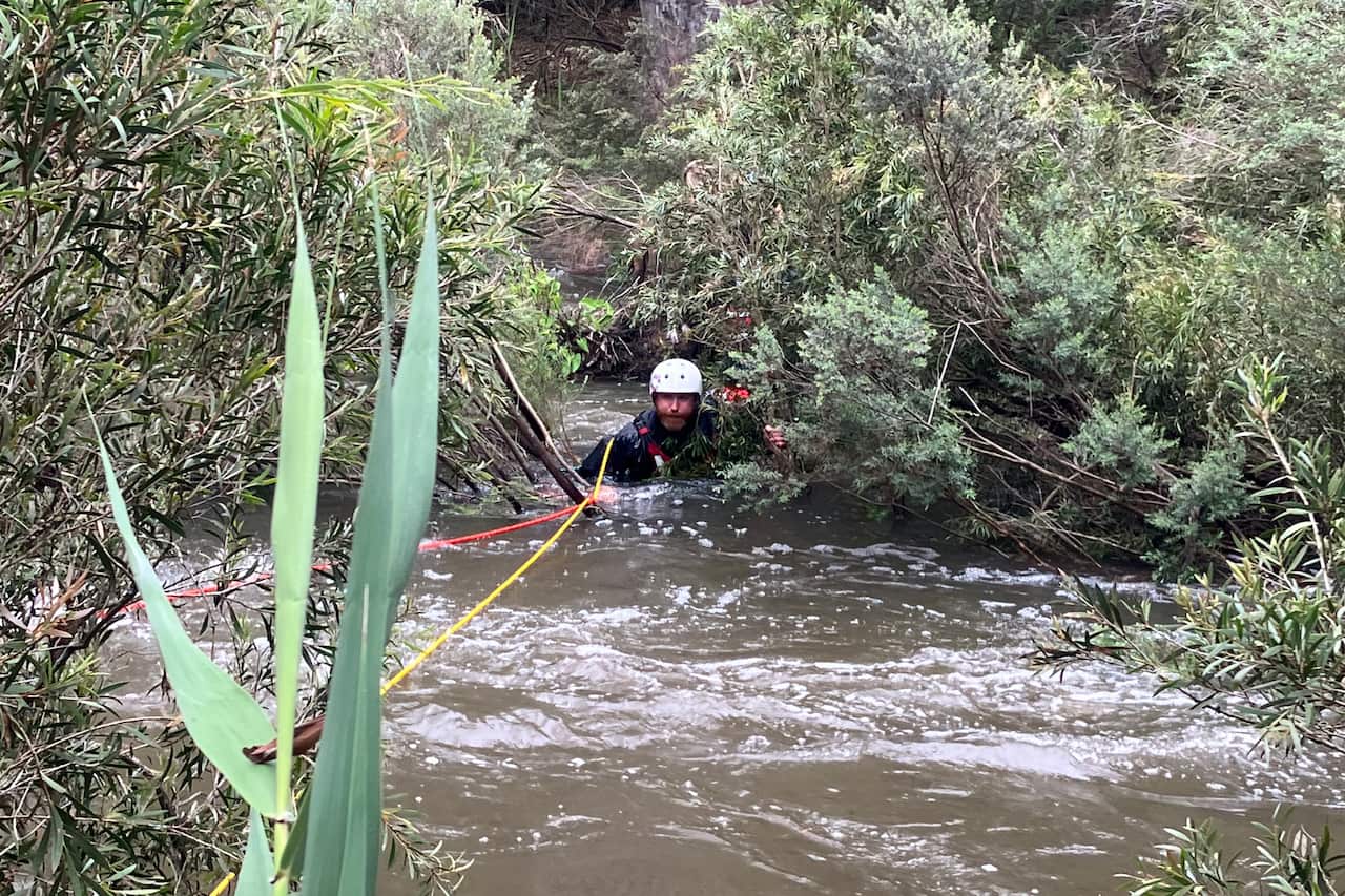 An emergency rescue worker in rapid waters
