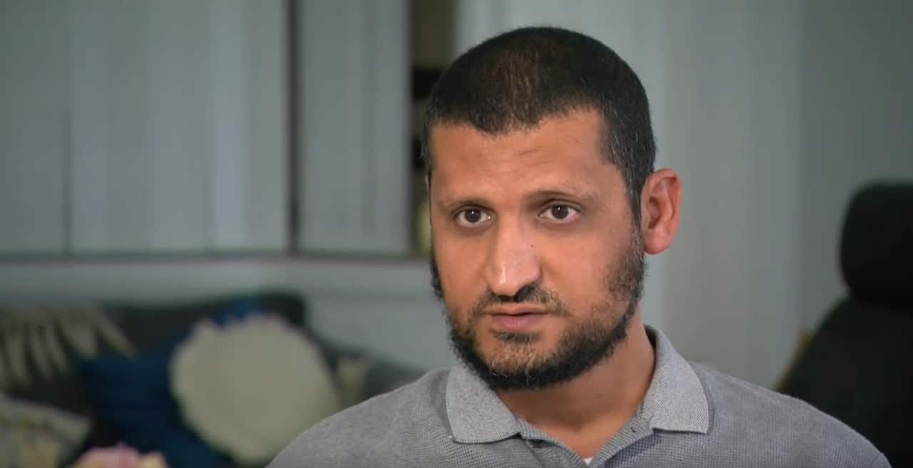 A man with a grey polo shirt.