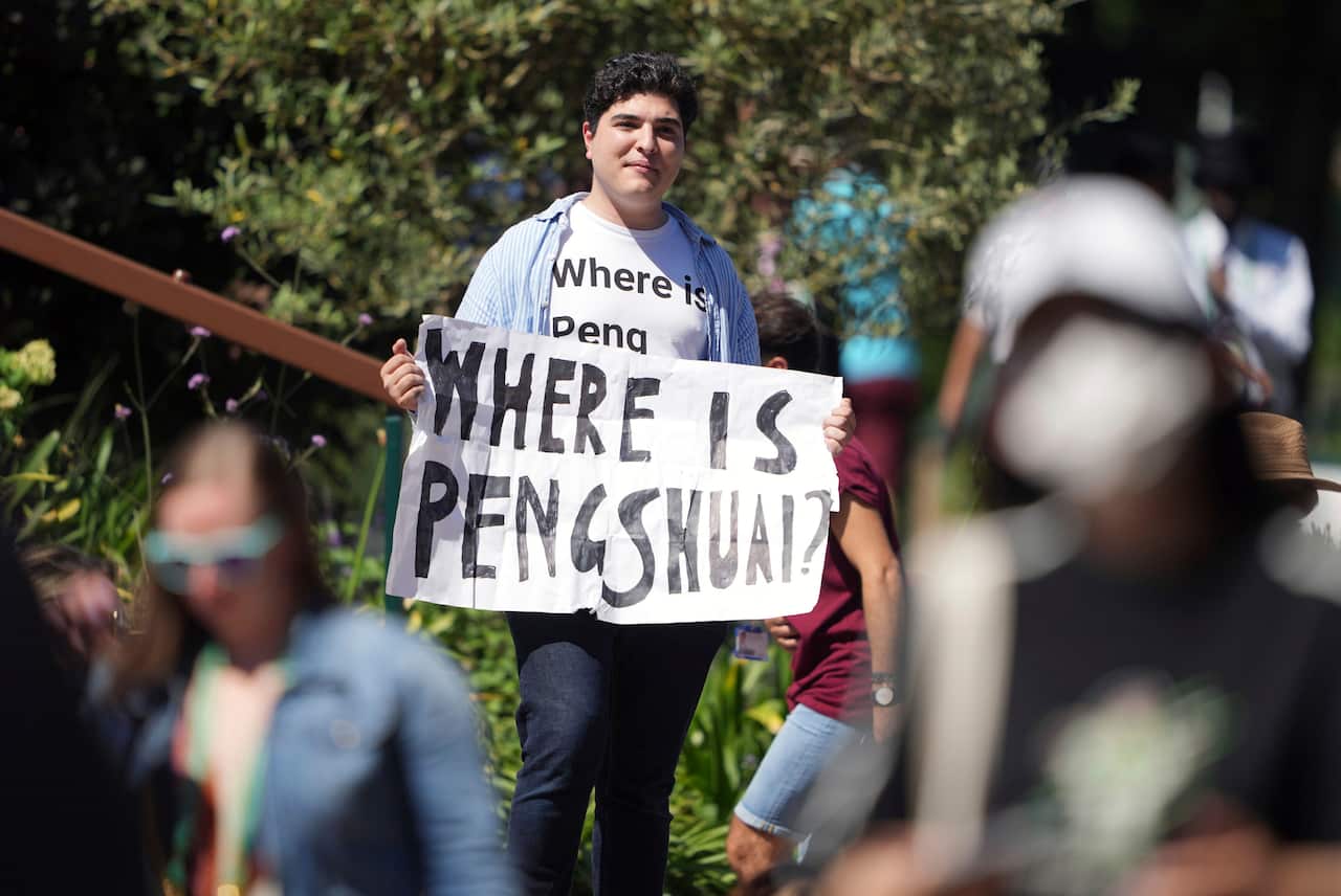 Protester, Drew Pavlou, holds a sign and wearing a t-shirt reading "where is Peng Shuai" on day twelve of the 2022 Wimbledon Championships at the All England Lawn Tennis and Croquet Club.