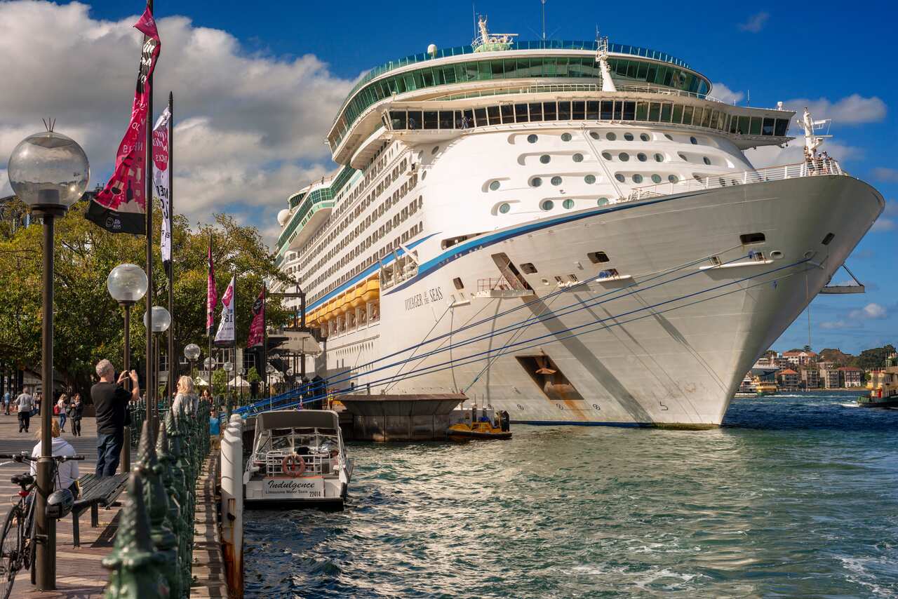 A large white cruise ship at a port
