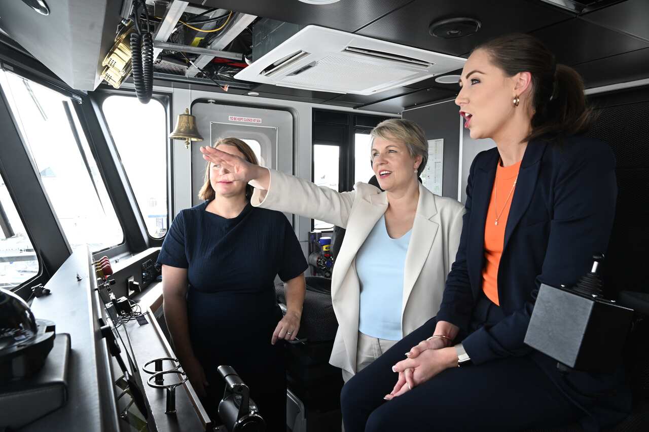 Three woman inside a cabin on a boat.