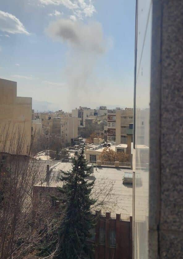 A collection of images shows thick plumes of grey smoke rising into the sky from behind urban apartment buildings in a densely populated city.