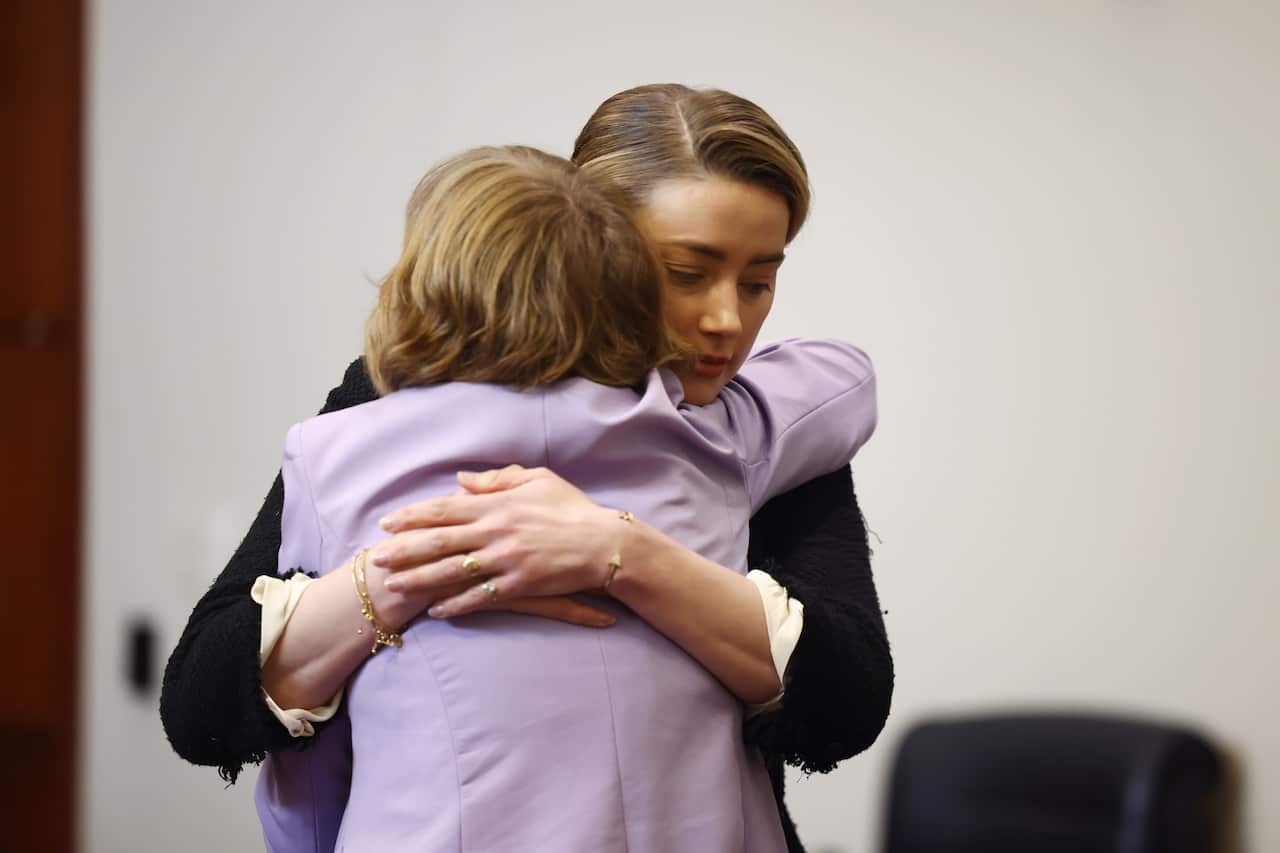 Two women hugging.
