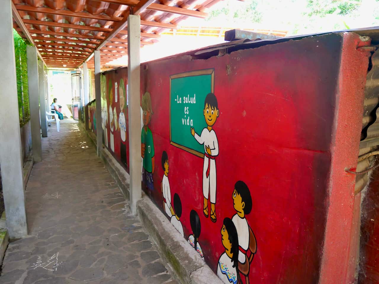 The alley invites clients with paintings of the program the clinic supports.