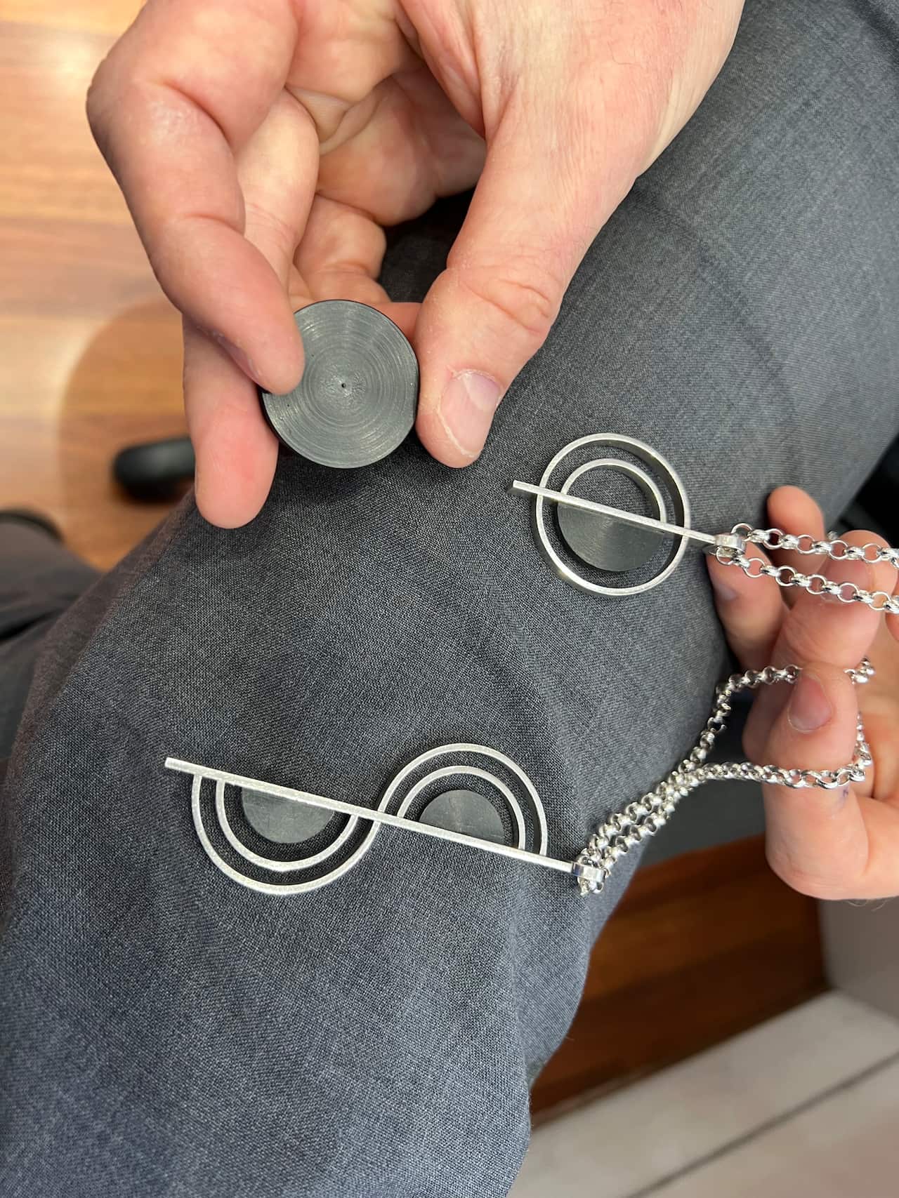 A person holding different items of jewellery. 