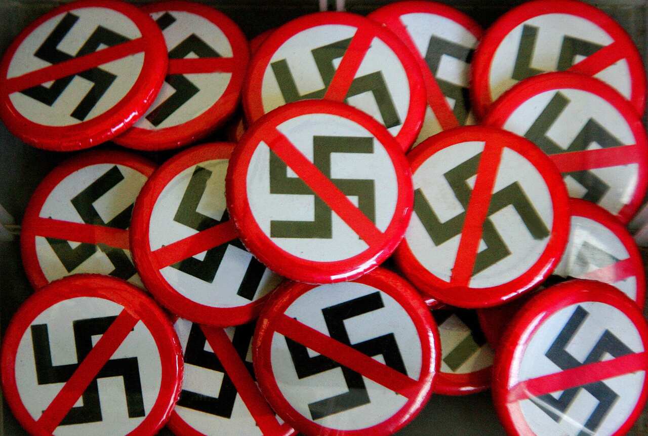 Badges of the Nazi swastika with the strikethrough symbol.
