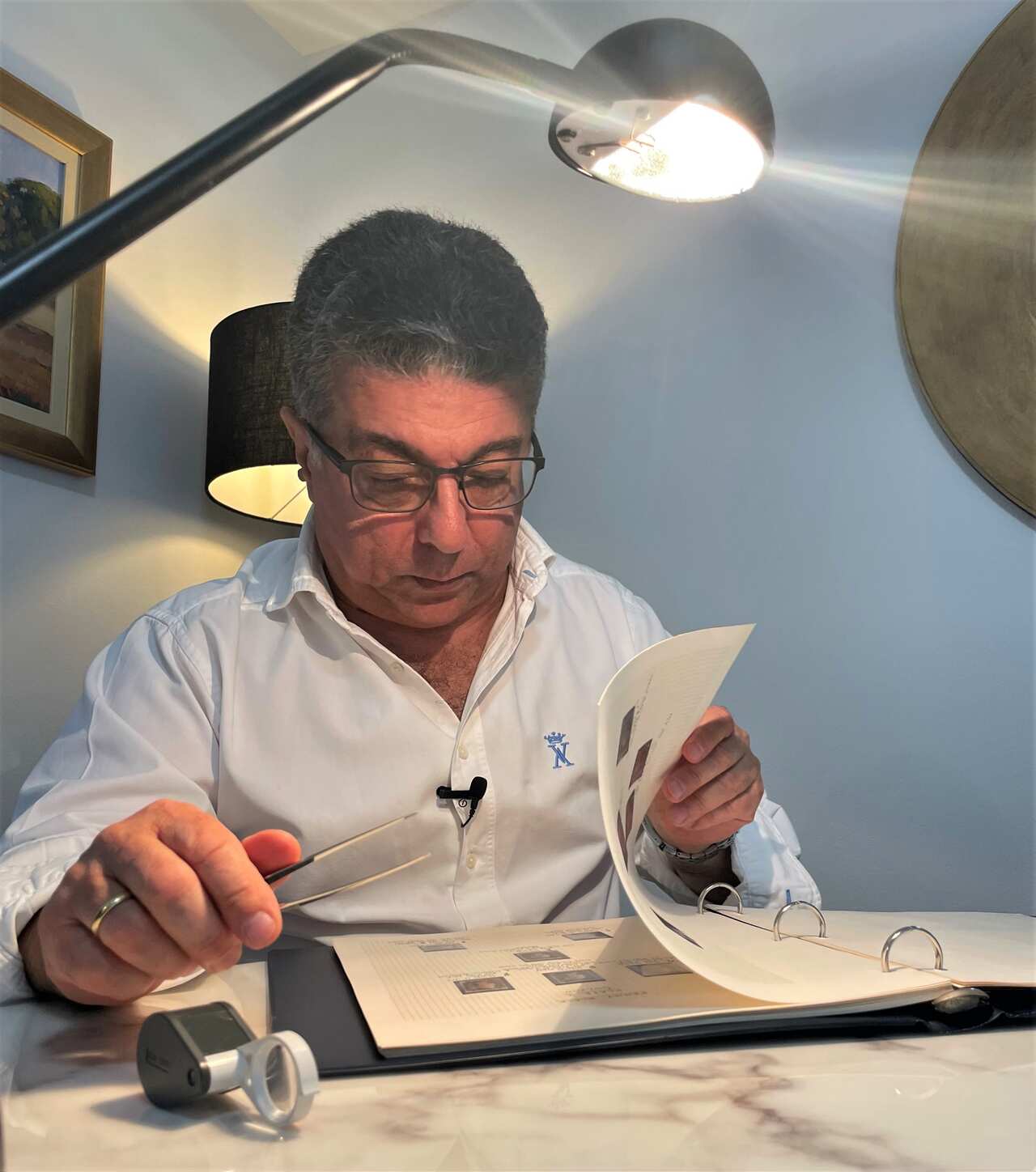 Michel Roussos looks at a stamp collection