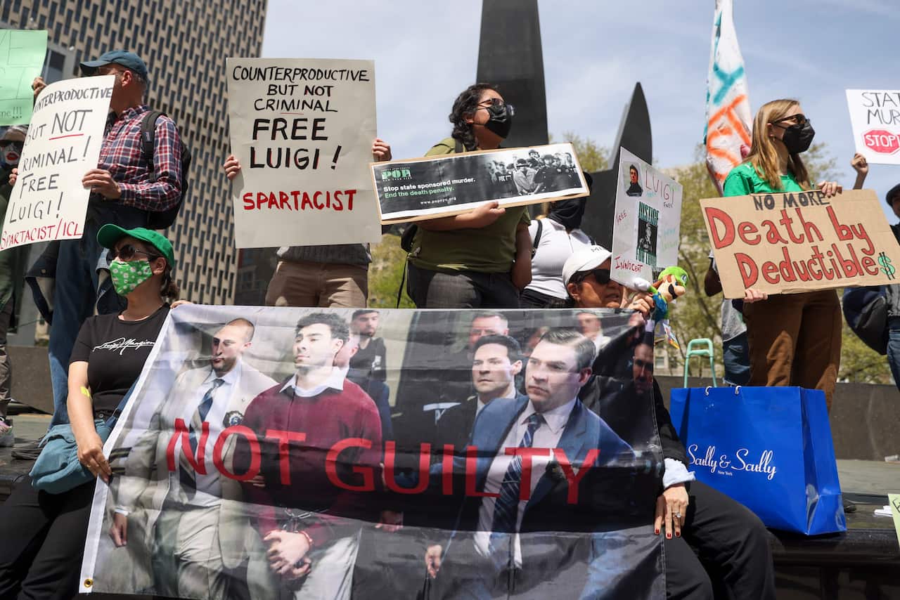A group of protesters holding up signs.