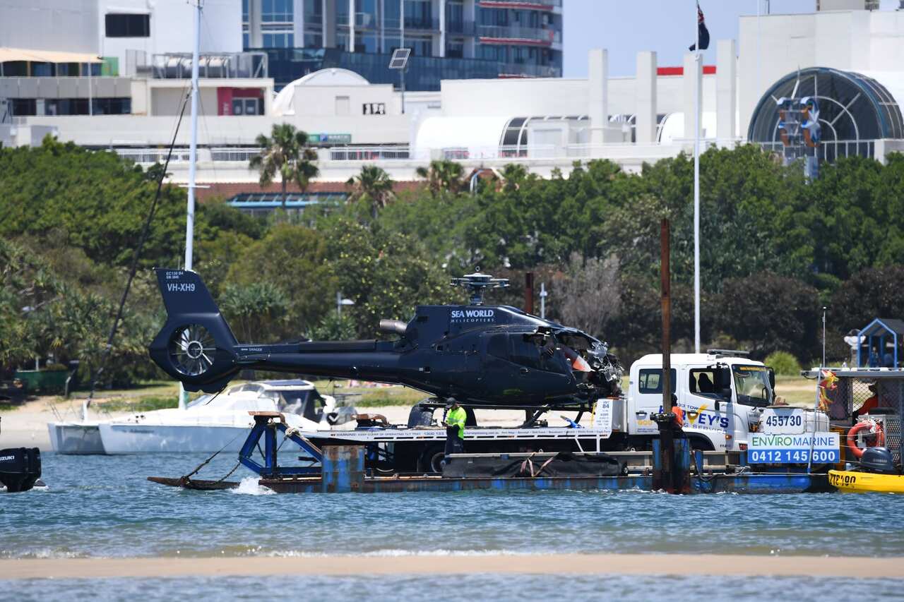 A damaged Helicopter is towed away on the Broadwater, on the Gold Coast, Tuesday, January 3, 2023. (AAP).jpg