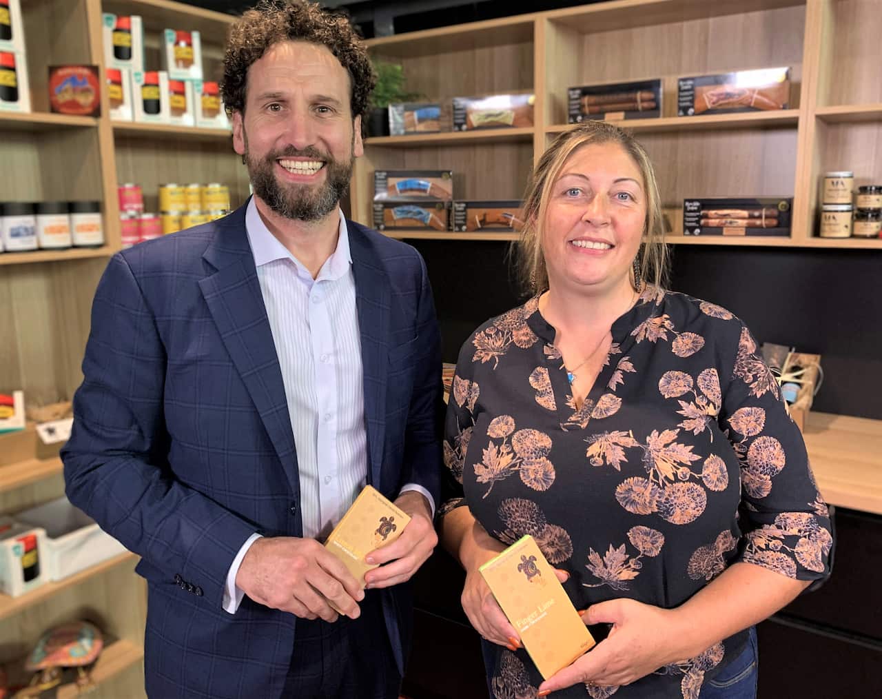 Sharon with Sean Armistead from IBA, holding her new chocolate range. 