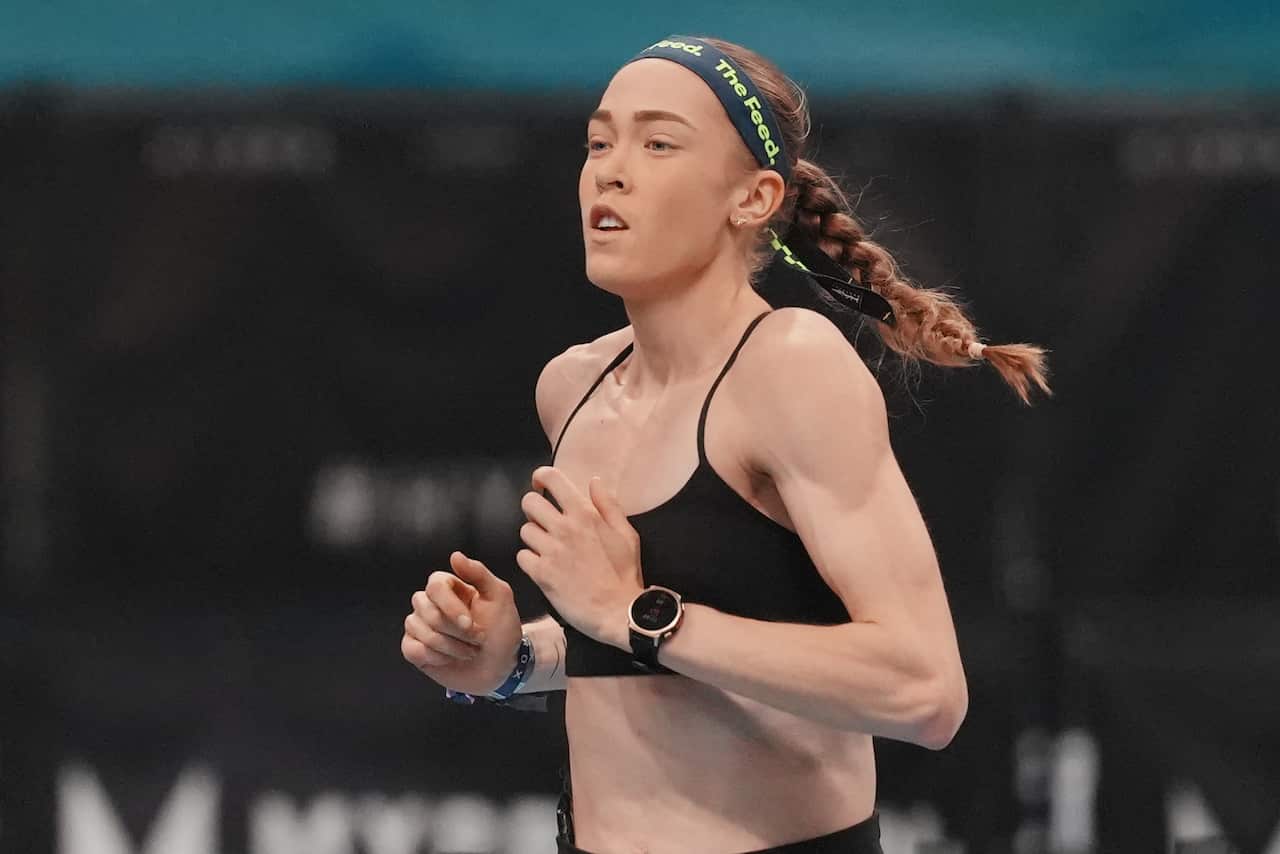 A woman in sporting gear is running.
