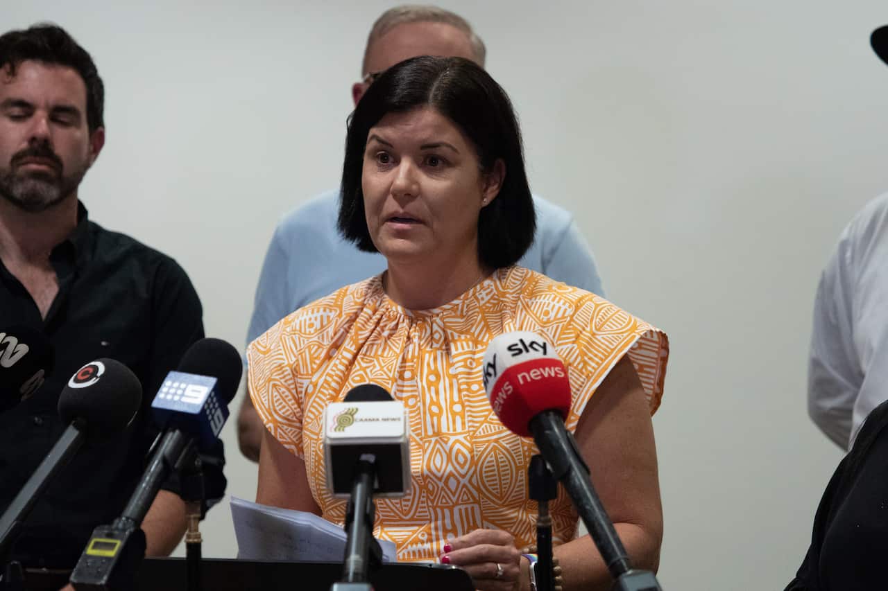 A woman addresses the media 