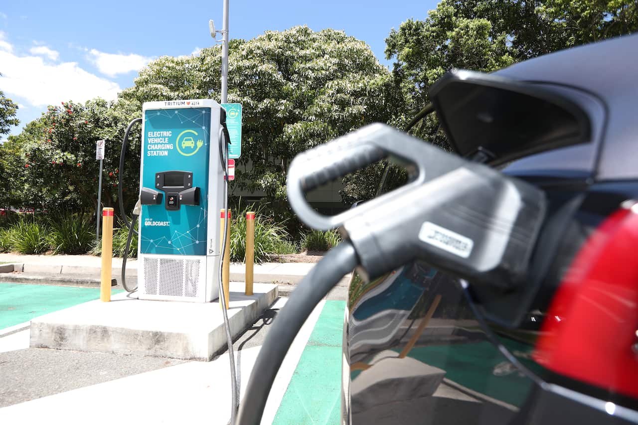 An electric vehicle plugged in at a charging station.